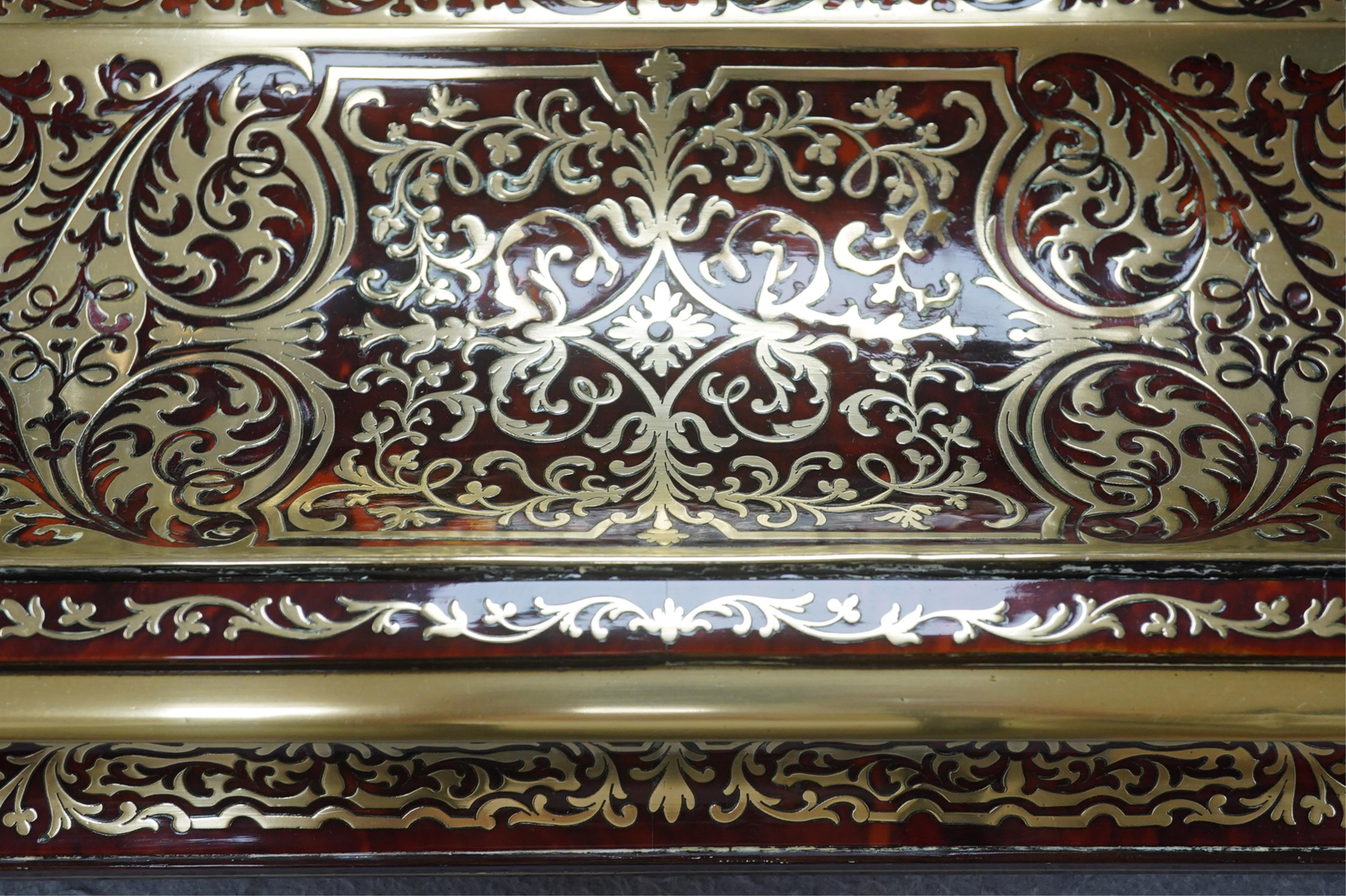 A French scarlet boullework double inkstand with original glass ink bottles c.1850, 39cm wide. Condition - inkstand good, one inkwell cover missing